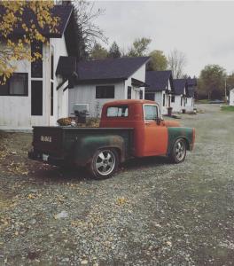 an old truck parked in front of a house at The Ridgeline | Near Saddleback • Walk to Rangeley Lake in Rangeley