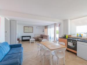 a living room with a blue couch and a table at Villa Mondello vista mare in Mondello
