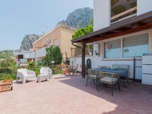 a patio with chairs and a table on a house at Villa Mondello vista mare in Mondello