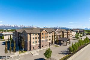 an aerial view of a building with a parking lot at Staybridge Suites Anchorage by IHG in Anchorage