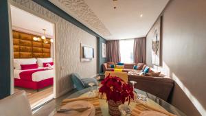a small living room with a couch and a bed at RENT-INN Suites Hotel in Rabat