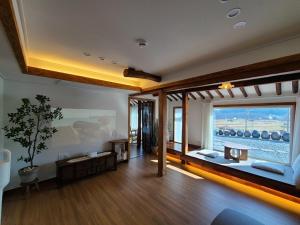 a living room with a large window with a view of the ocean at Namhae Choncangs in Namhae