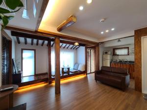a living room with a couch and a kitchen at Namhae Choncangs in Namhae +59 photos