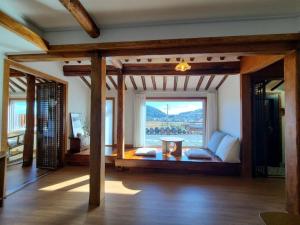 a living room with a couch and a large window at Namhae Choncangs in Namhae
