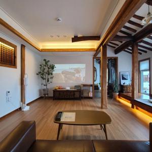 a living room with a couch and a table at Namhae Choncangs in Namhae