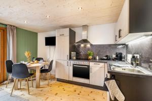 a kitchen with a table and a stove top oven at Haus Helena Sophia in Au +35 photos