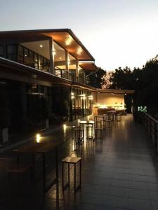 a building with tables and chairs in front of it at Pagoda Sight Residence in Nan