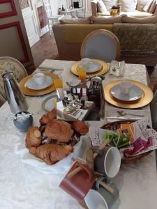 a table with plates and food on top of it at BB des 6 arcs"" in Coulonces