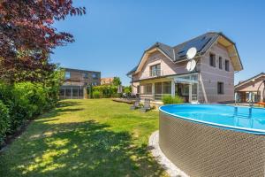 a house with a swimming pool in a yard at Luxusní vila Serenity 15 min od Prahy in Beroun