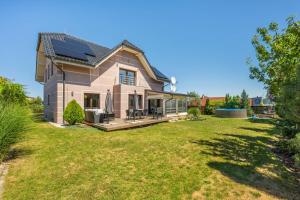 a house with a solarium and a yard at Luxusní vila Serenity 15 min od Prahy in Beroun