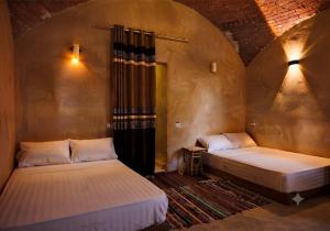two beds in a room with at Mezorin Farm & Hot Spring - Peaceful Eco-Retreat & Private Stay in Siwa