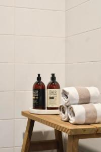 a table with two bottles of wine and towels at Villa Lydia Lapland - Private Sauna & Aurora View in Rovaniemi