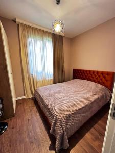 a bedroom with a bed and a window at "Mtis broli 77"-Mzetamze-Borjomi in Mzet'amze