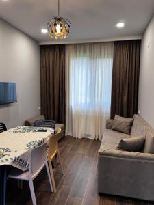 a living room with a couch and a table at "Mtis broli 77"-Mzetamze-Borjomi in Mzet'amze