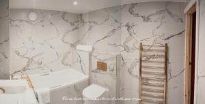 a white bathroom with a marble wall at The Priory House in Tynemouth +63 photos