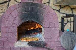 a brick oven with two pizzas in it at Maasai ecoLodge in Karatu