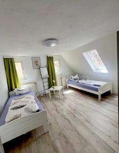 two beds in a room with green curtains at Schönste Aussicht in Königstein an der Elbe