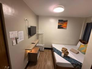 a hospital room with a bed and a desk at Mongki's Pension House in Puerto Princesa City