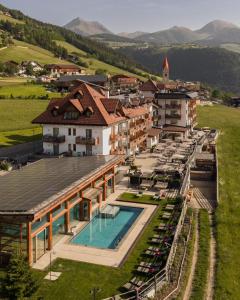 an aerial view of a resort with a swimming pool at Natur & Aktiv Hotel Rogen in Mühlbach