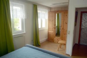 a bedroom with a bed and a door and windows at Schönste Aussicht in Königstein an der Elbe +11 photos