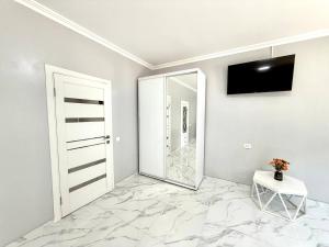 a white room with a mirror and a door at Apartment HOME две спальни in Reni