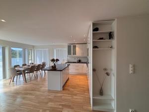 a kitchen and dining room with a table and chairs at Cozy Scandinavian Retreat in Sola