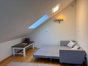 a living room with a bed and a table at Cozy Scandinavian Retreat in Sola