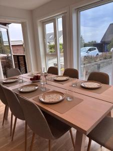 a dining room table with plates and glasses on it at Cozy Scandinavian Retreat in Sola +34 photos