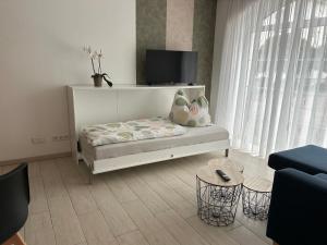 a white room with a bed and a window at Ferienwohnung Zweinig 06 in Zweinig