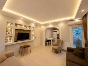 a living room with a couch and a tv at Pasha Residence in Trabzon