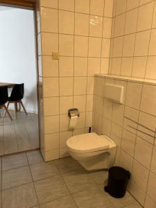 a bathroom with a toilet and a table at Ferienwohnung Zweinig 06 in Zweinig