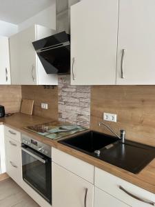 a kitchen with a sink and a stove at Ferienwohnung Zweinig 06 in Zweinig