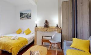 a bedroom with a bed and a desk and a chair at Authentic Residence from 1792 - Caujac in Caujac