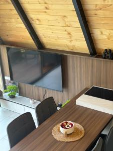 a dining room with a table with a bowl of fruit on it at LiLo s Villa in Ferizaj