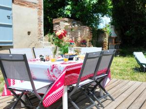 a table with a red and white table cloth at Authentic Residence from 1792 - Caujac in Caujac