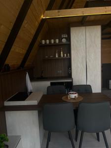a kitchen with a table and chairs and a counter at LiLo s Villa in Ferizaj