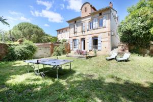a ping pong table in front of a house at Authentic Residence from 1792 - Caujac in Caujac