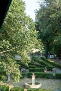a garden with a fountain and trees and bushes at Château de Mons Gard in Mons +11 photos