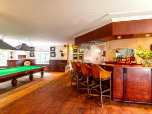 a kitchen with a pool table and a bar at Blue Mountain Estate in Hazyview