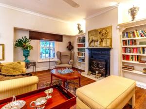 a living room with a fireplace and a couch at Blue Mountain Estate in Hazyview