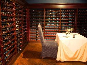 a dining room with a table and a wine cellar at Blue Mountain Estate in Hazyview