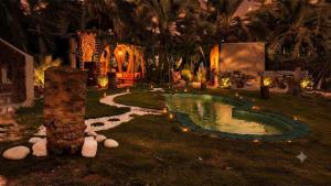 a garden with a small pond in the yard at Mezorin Farm & Hot Spring - Peaceful Eco-Retreat & Private Stay in Siwa