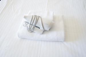 a pile of white towels on a bed at Hotel Sunset ZANPA in Yomitan +13 photos