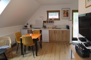 a kitchen and dining room with a table and chairs at Apartmá Jablonec in Jablonec nad Nisou