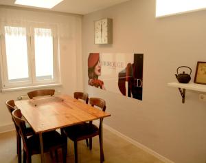 a dining room with a wooden table and chairs at Schönste Aussicht in Königstein an der Elbe