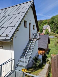 a house with a metal roof and stairs at Apartmá Jablonec in Jablonec nad Nisou