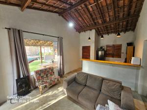 a living room with a couch and a fireplace at Sito Marinheiro in Porto Seguro