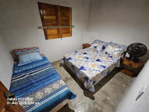 a bedroom with a bed and a small bed sidx sidx sidx at Sito Marinheiro in Porto Seguro +22 photos
