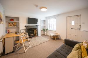 a living room with a couch and a fireplace at 10 Northgate, Beccles in Beccles