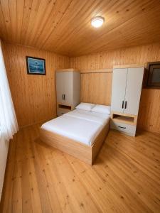 a bedroom with a bed in a wooden room at Ena Suites in Çaykara